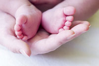Cute little baby feet in a womans hands!